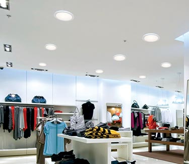 Several Natural Light commercial hard ceiling tubular skylights in clothing store thumb